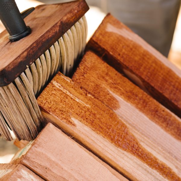 person-varnishing-wood-with-big-brush