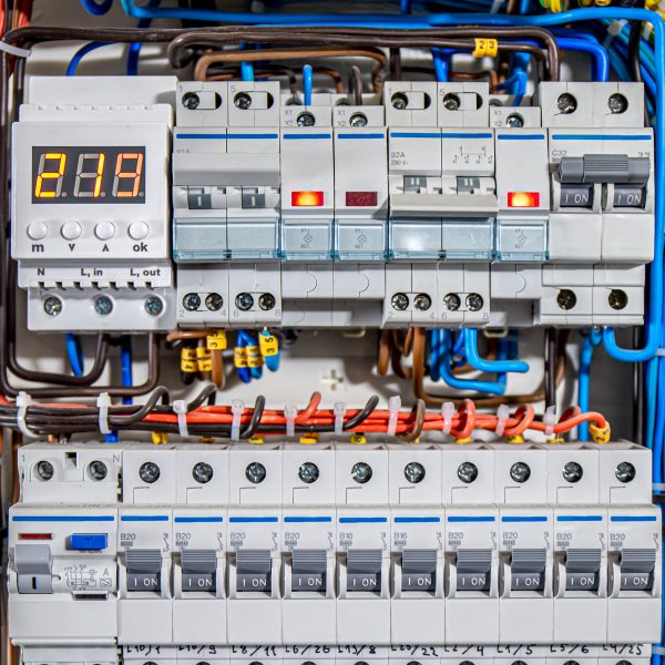 Switchboard equipment. Shield for enterprise electrification. Switchboard for control over electrical equipment. Labeled panel with wires and switches at enterprise.